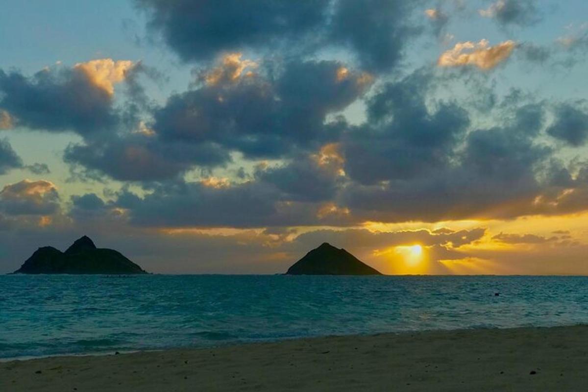 una posta de sol a la platja amb dues illes a l'oceà