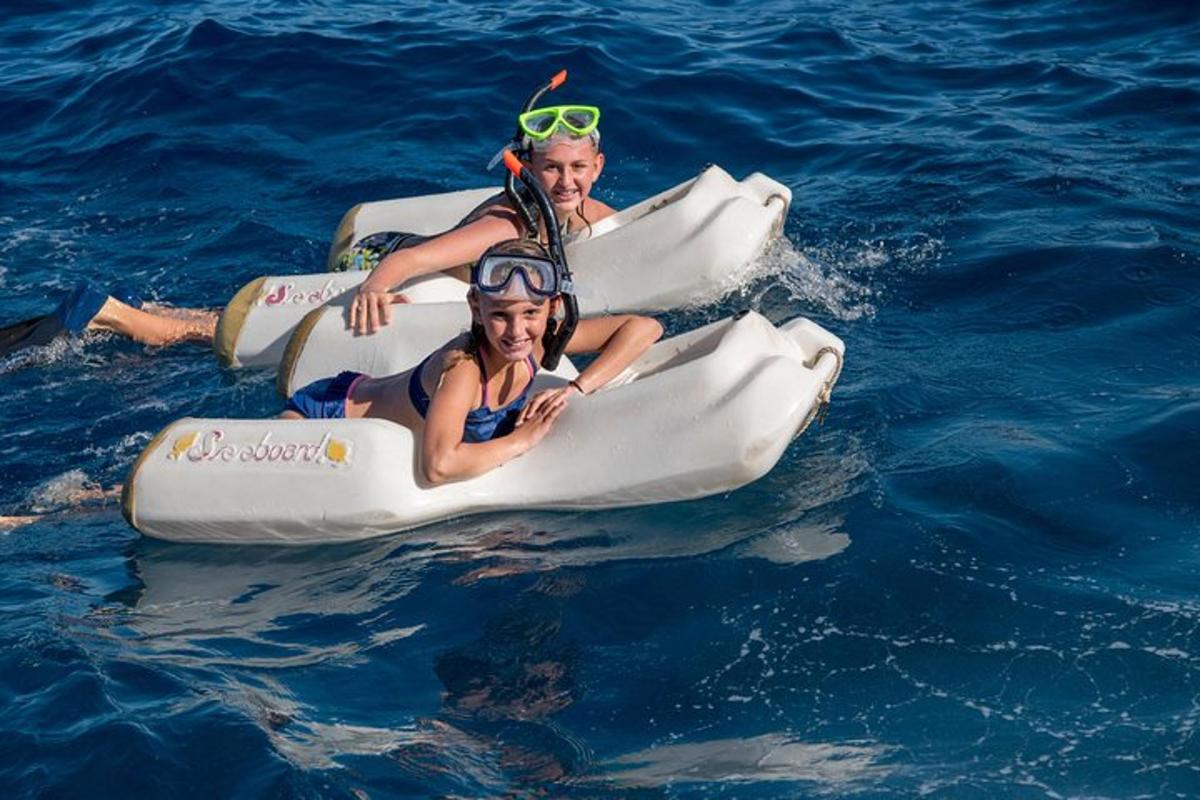 two girls are riding on an inflatable raft in the water