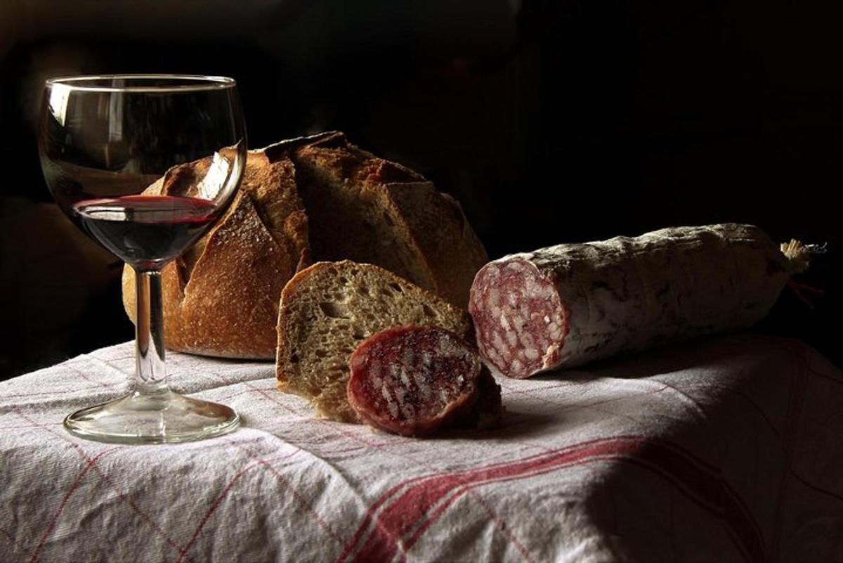 a glass of wine and some bread and cheese
