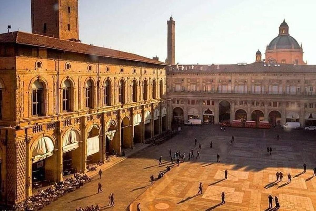 a group of people walking around a large building