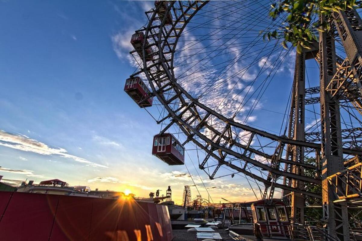 a ferris wheel with the sunset in the background