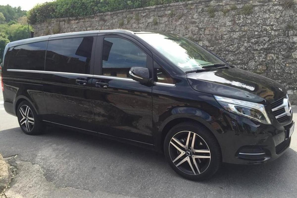 a black van parked next to a stone wall