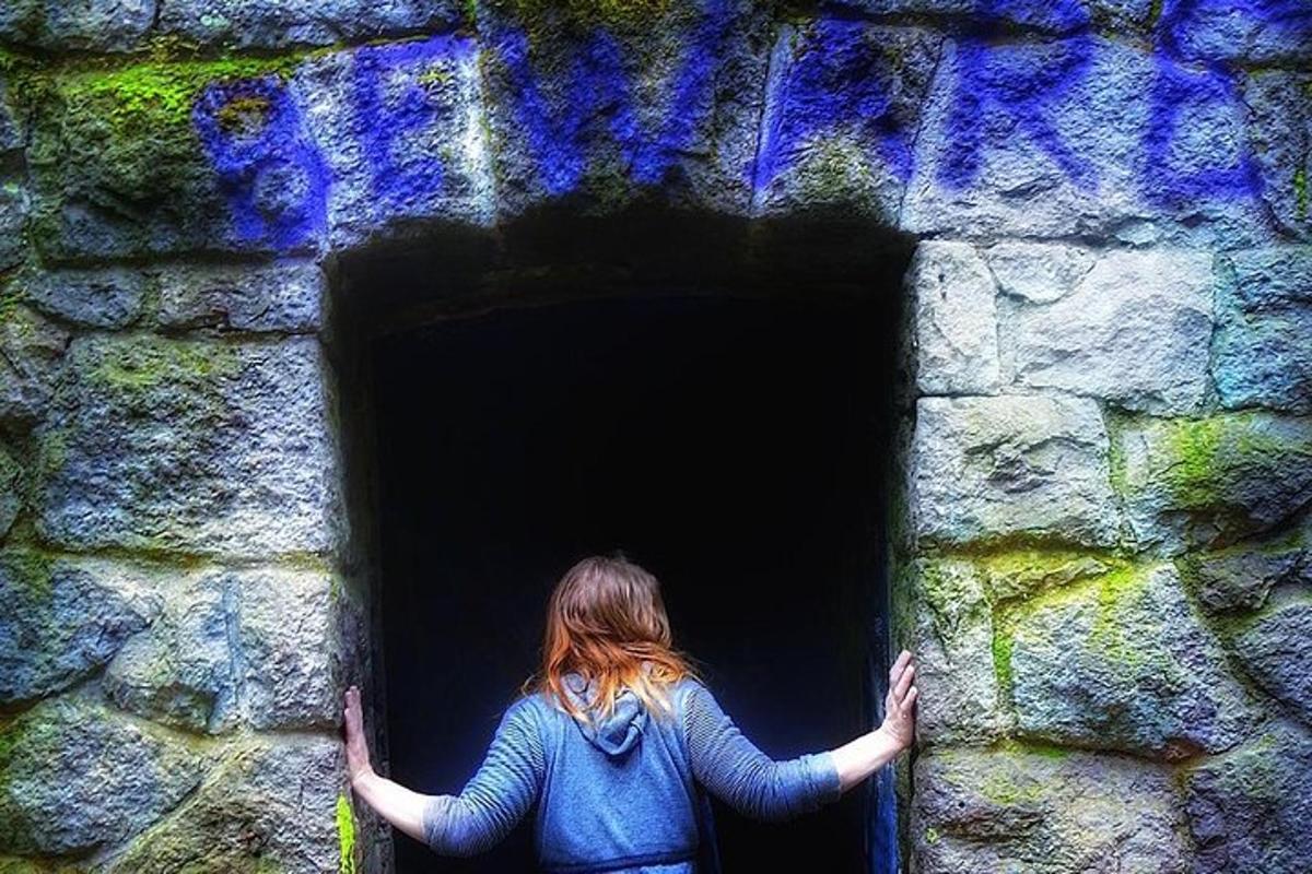 a woman is standing in a brick tunnel