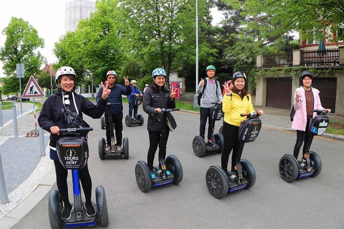 a group of people riding segways down a street