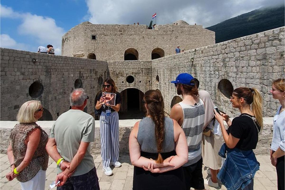 a group of people standing outside of a castle