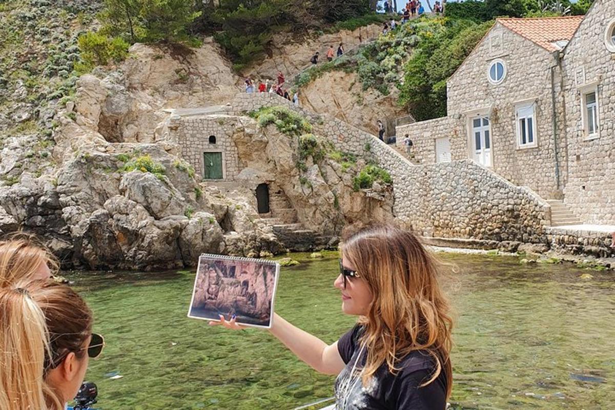 a woman holding up a picture in the water