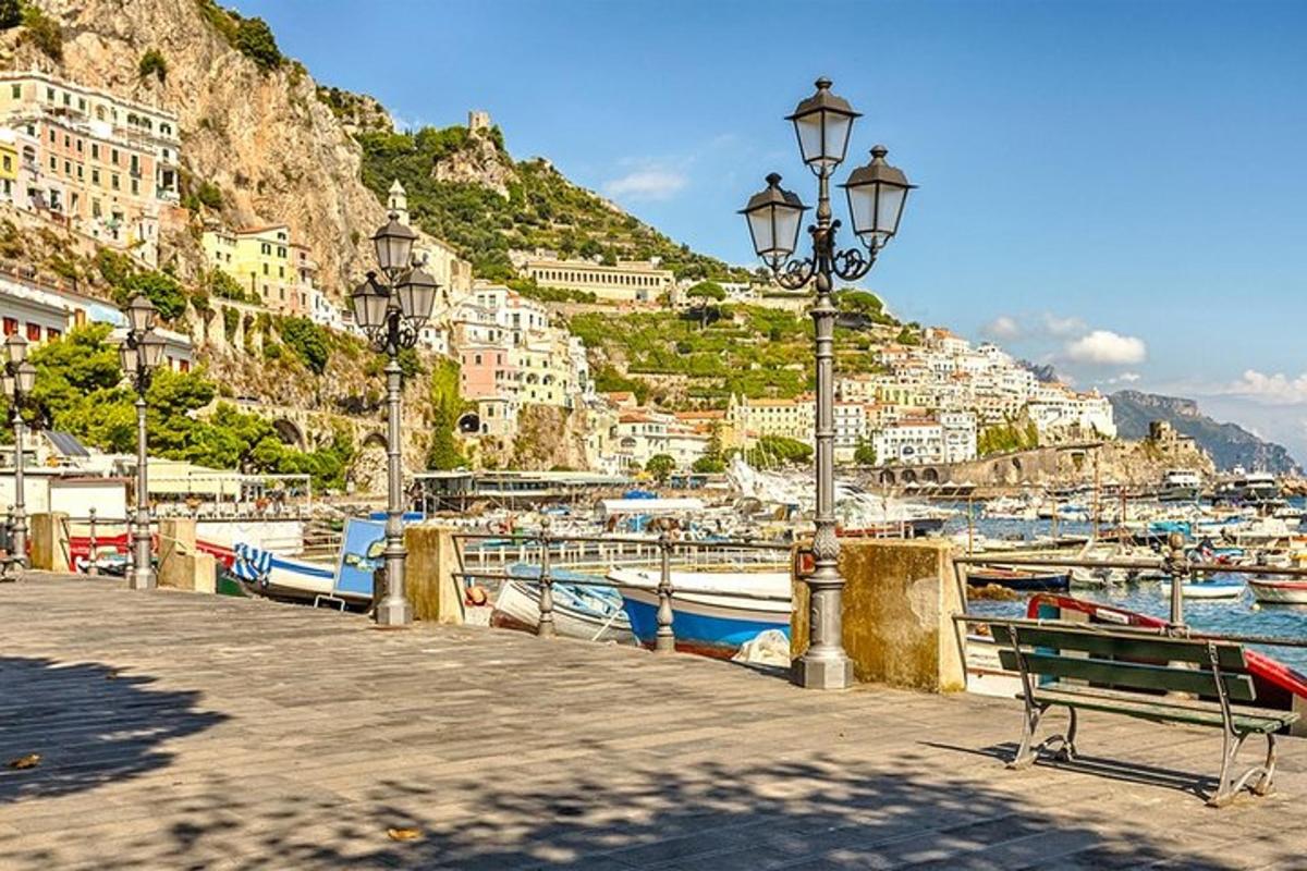 a dock with a bench and boats in a harbor