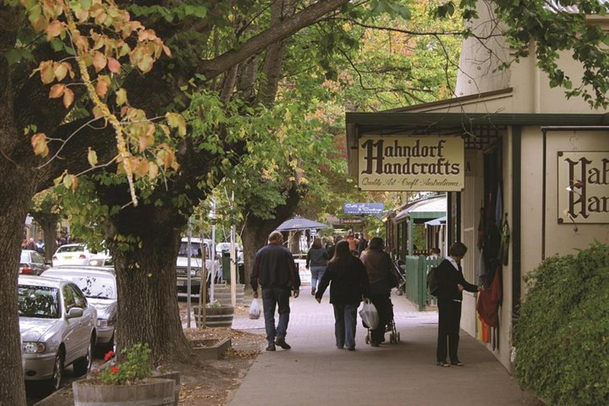 a group of people walking down a sidewalk