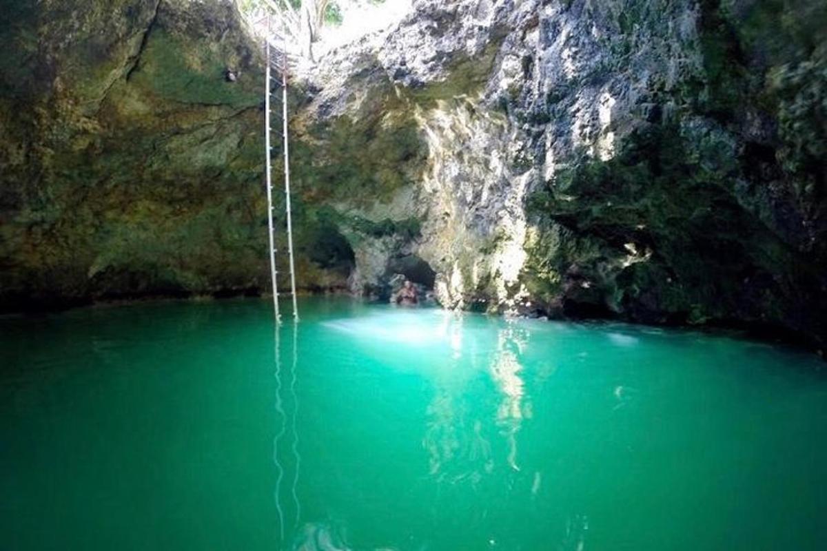 una piscina di acqua verde smeraldo in una grotta