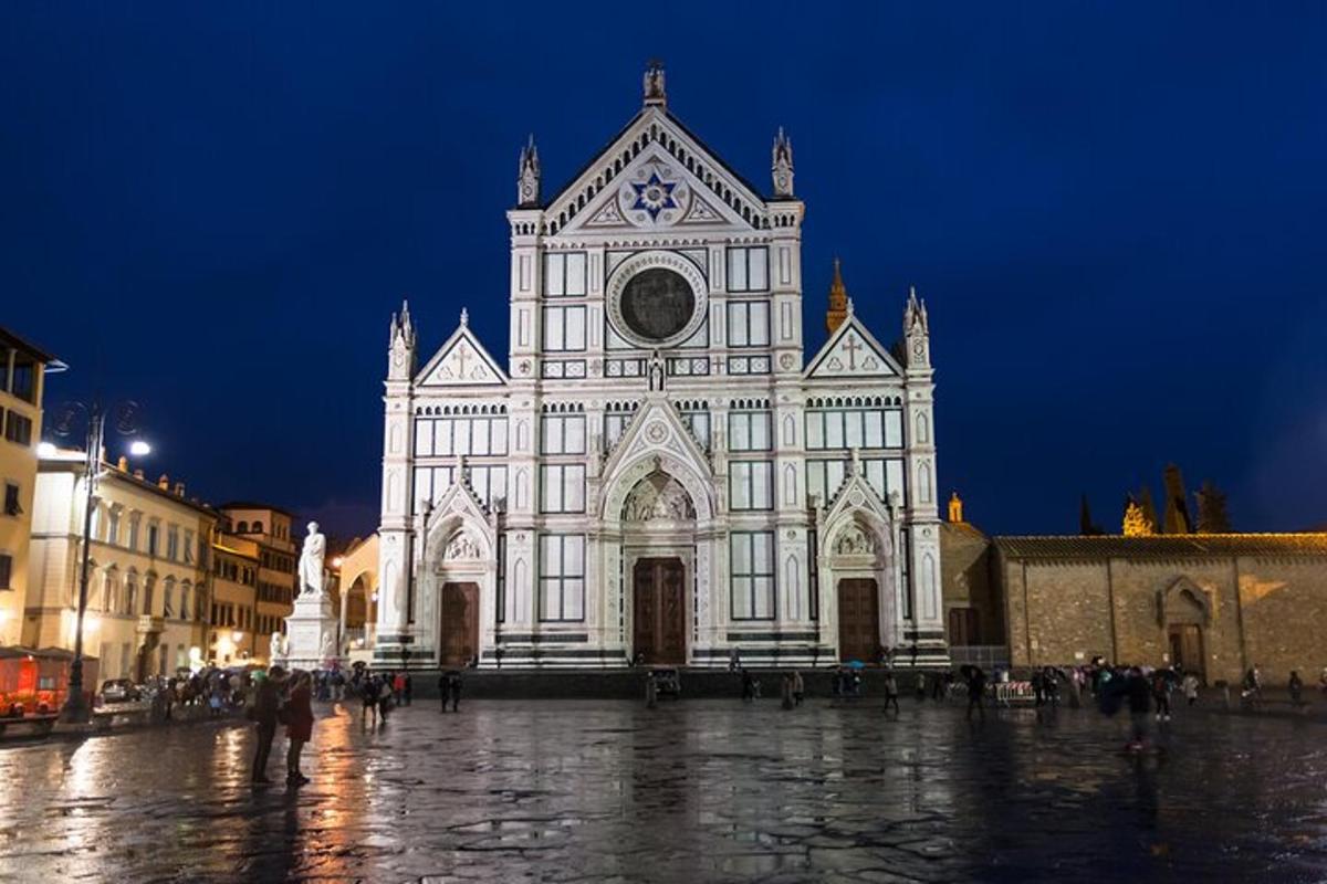 a large white church with a clock tower at night