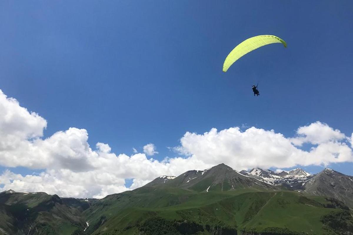 oseba, ki leti s padalom nad goro