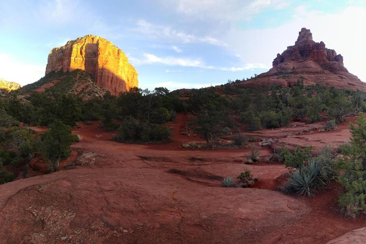a view of a desert with two large rock formations