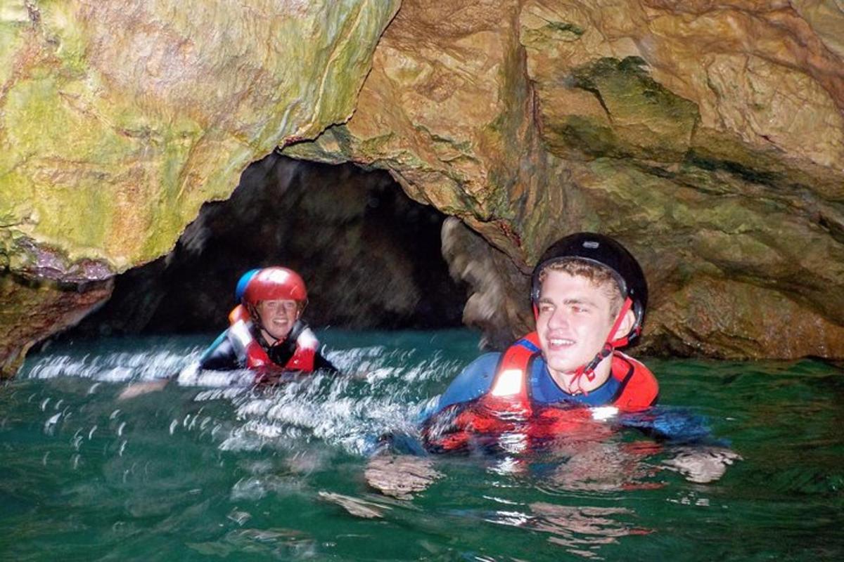 een paar mensen in het water in een grot