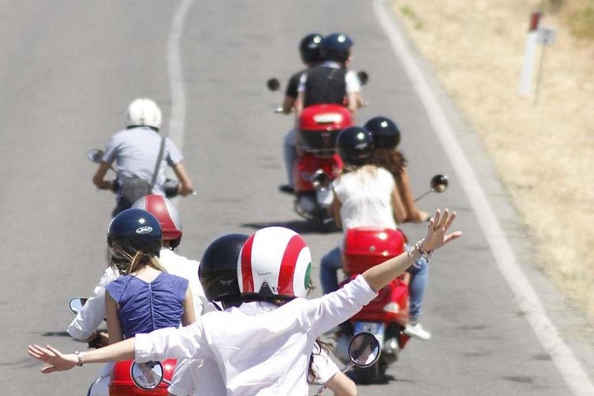a group of people riding motorcycles on a road