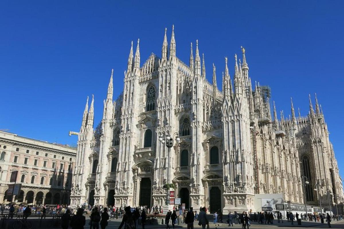 a large cathedral with people standing in front of it