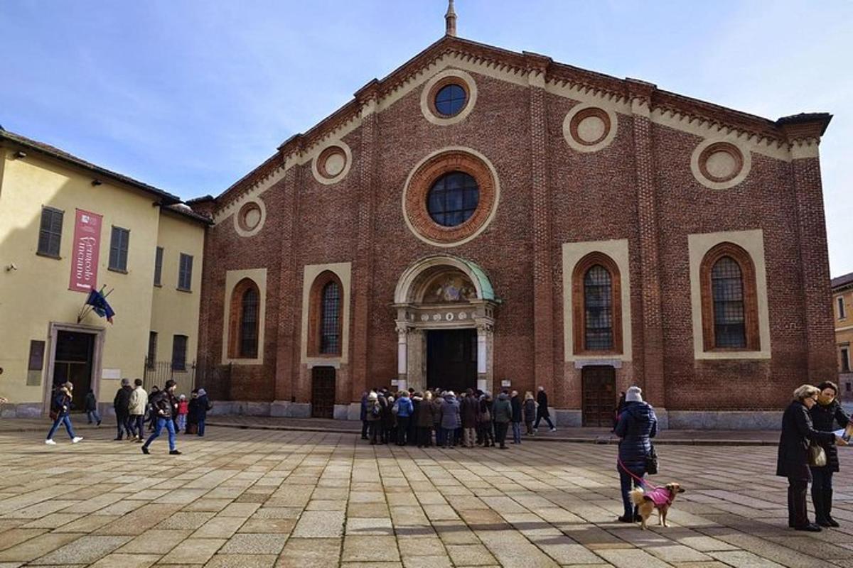 a group of people standing in front of a large brick building