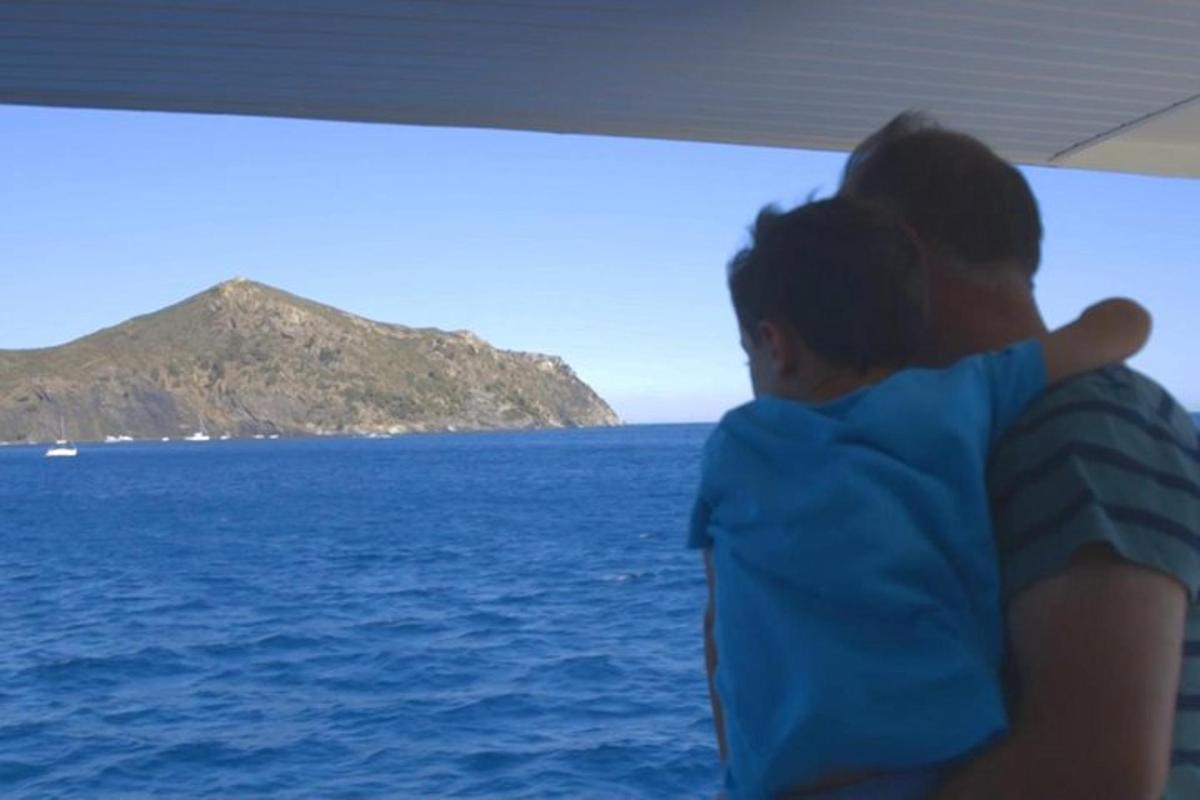 a man and a woman looking out at the ocean