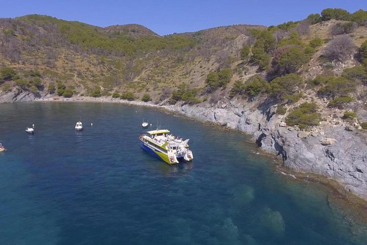 a boat in a body of water next to a mountain