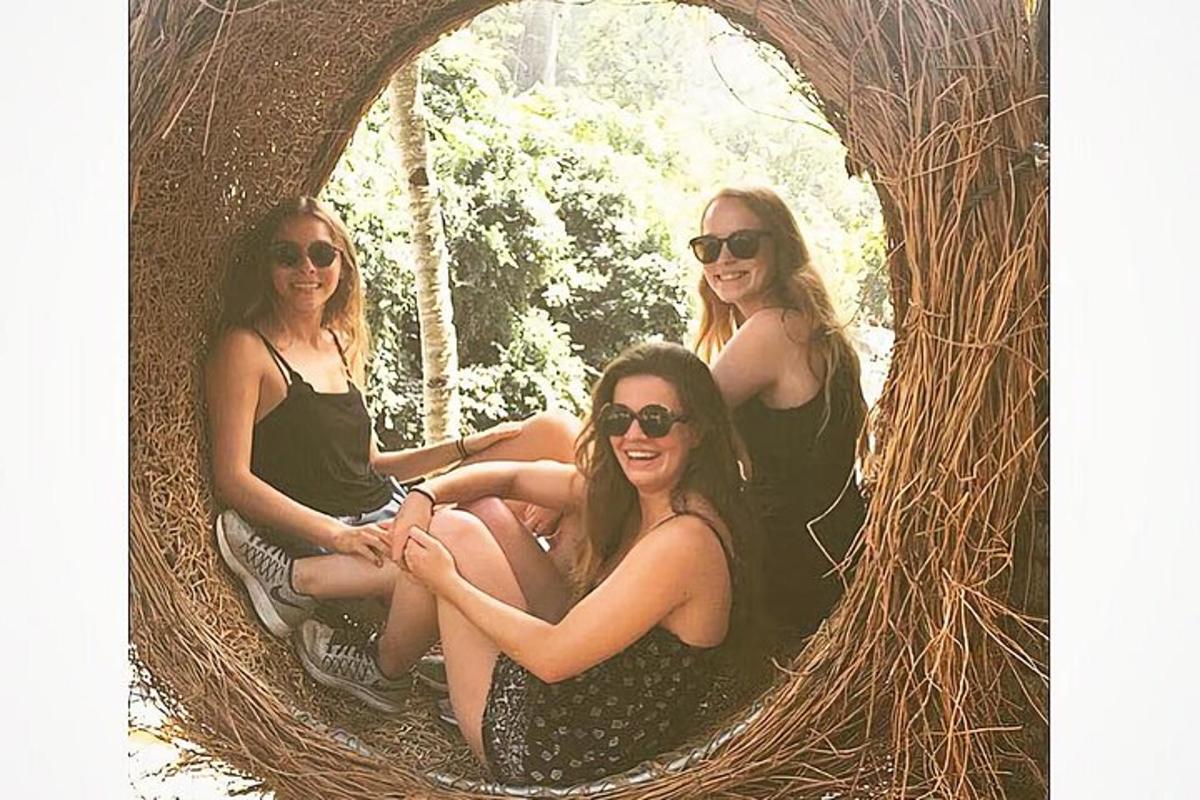 a group of women sitting in a round hole