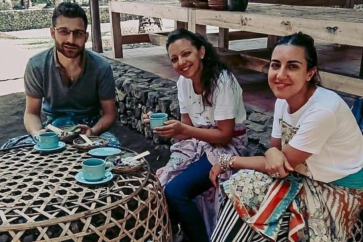 a group of three people sitting at a table