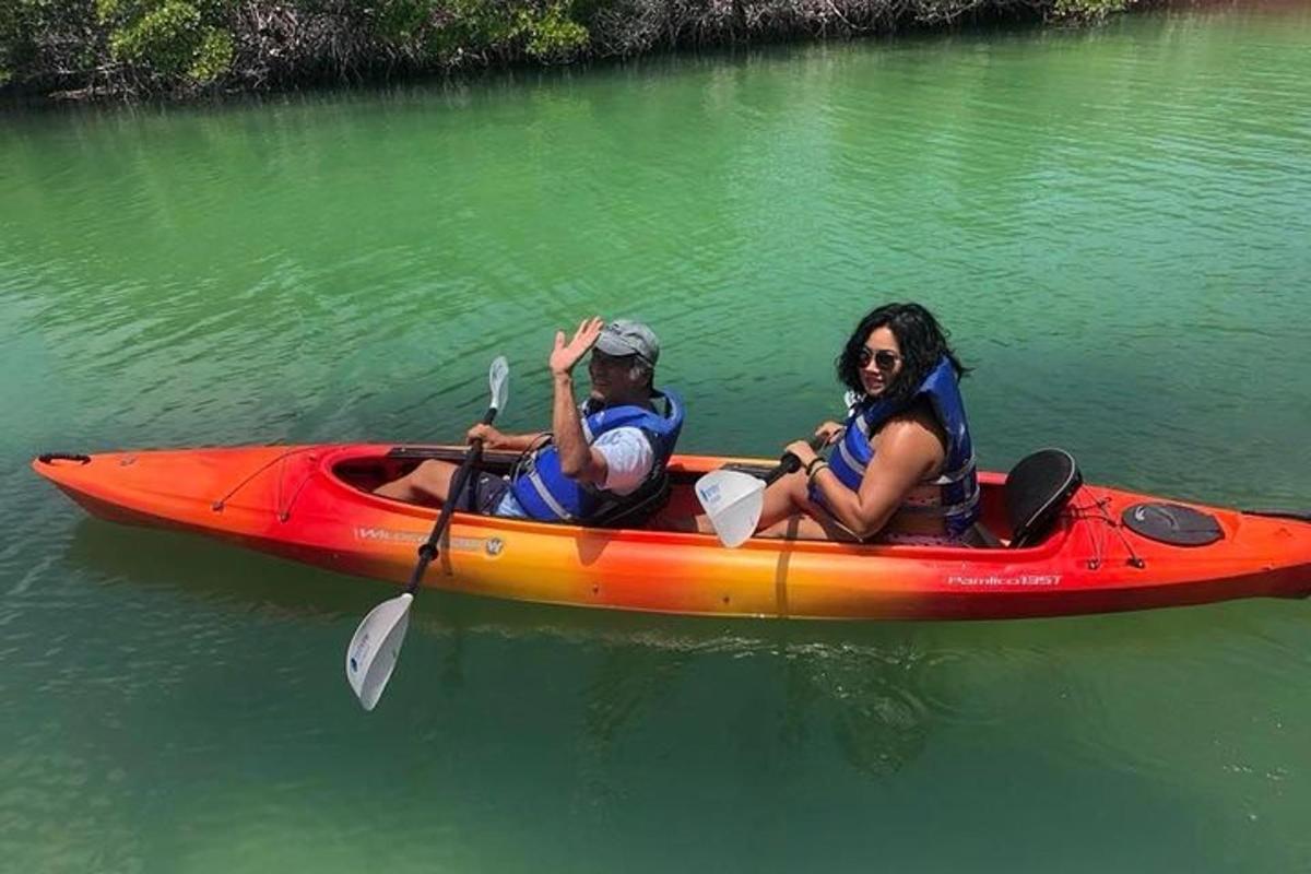 a man and a woman in a kayak on the water