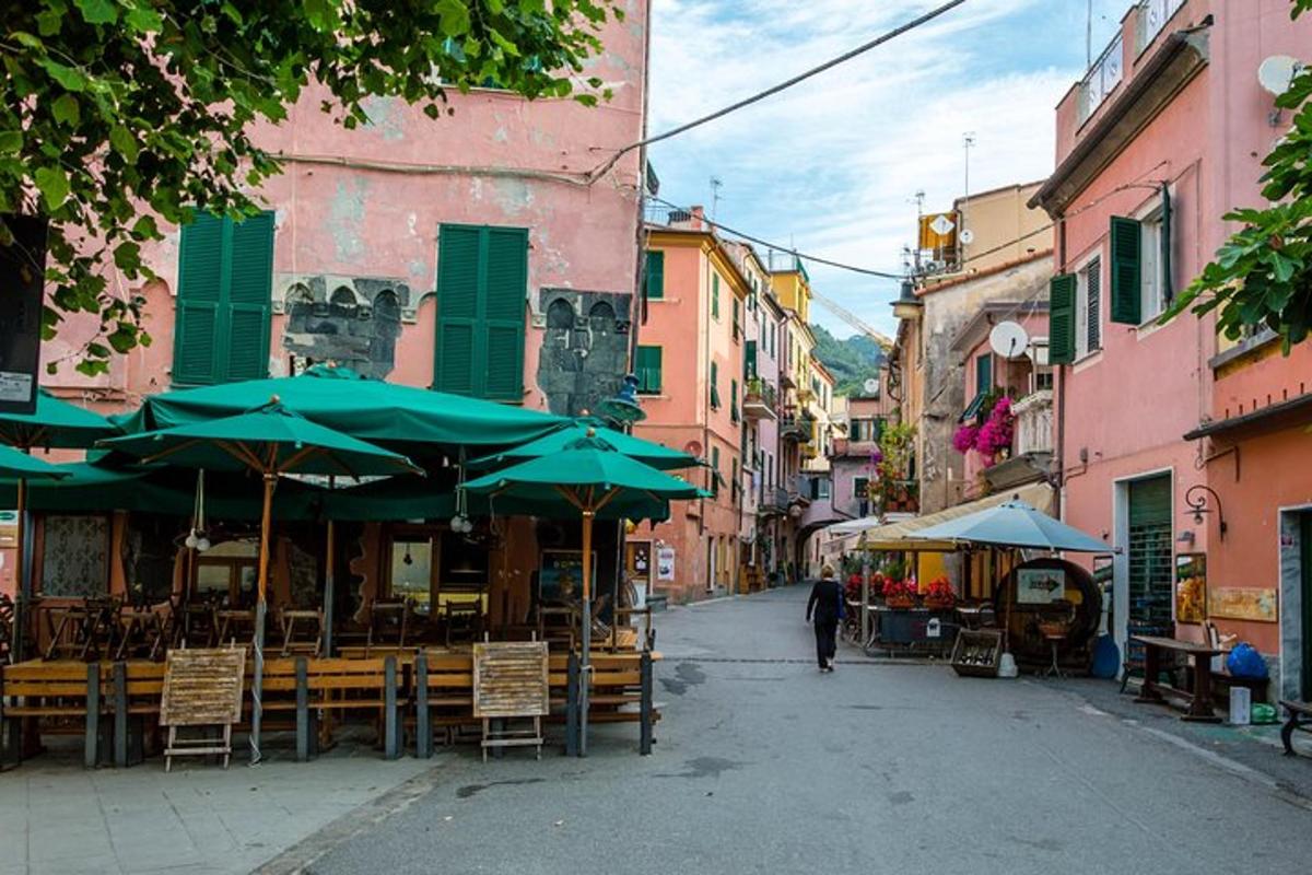 a street with tables and umbrellas in an alley