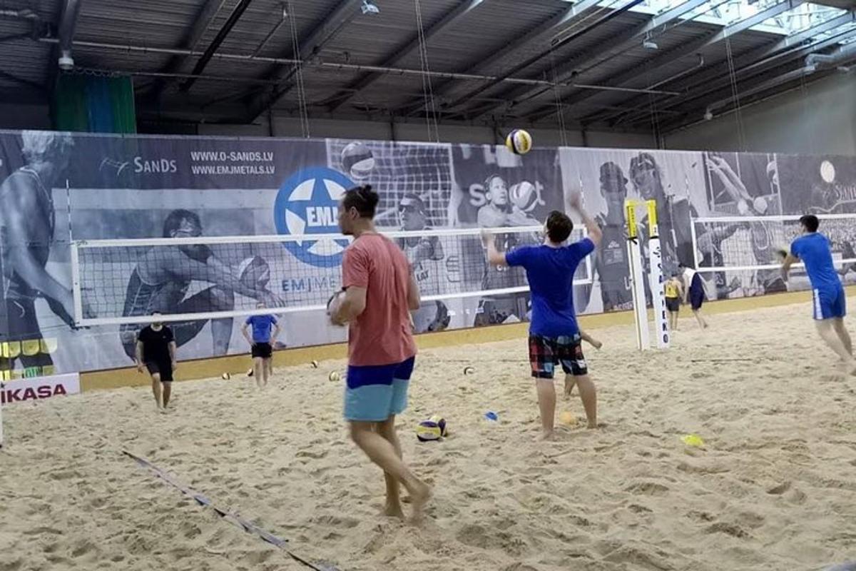 um grupo de pessoas jogando vôlei na praia