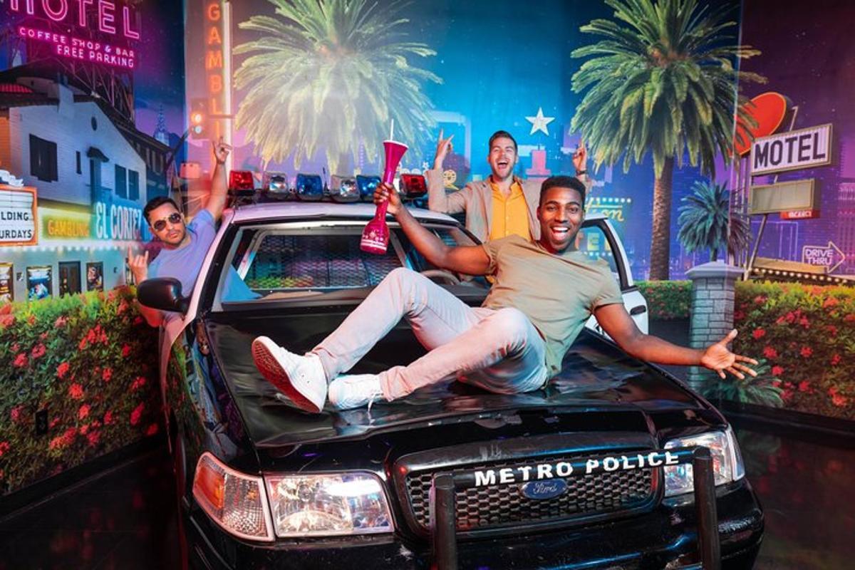 a man is laying on the hood of a car
