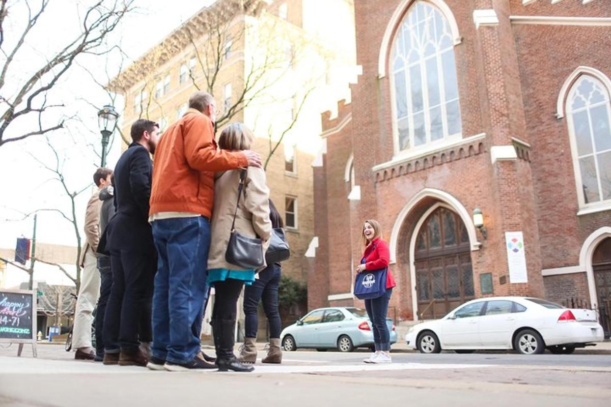 a group of people standing on a sidewalk in front of a building