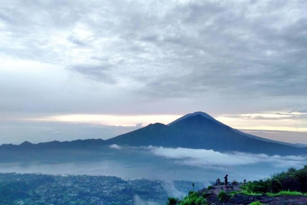 a view of a mountain in the sky with clouds