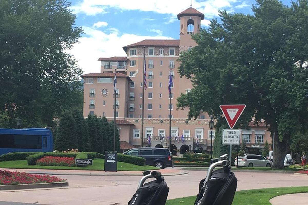 two parking meters in front of a large building
