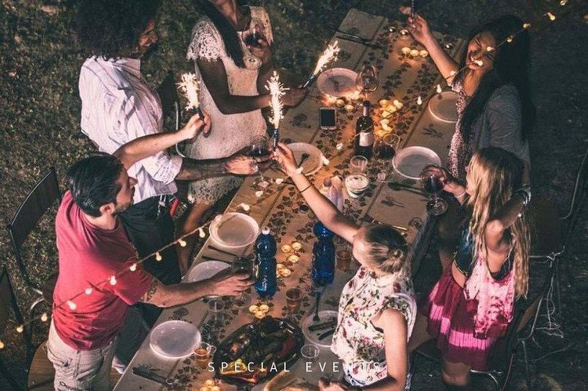 a group of people standing around a table at a party