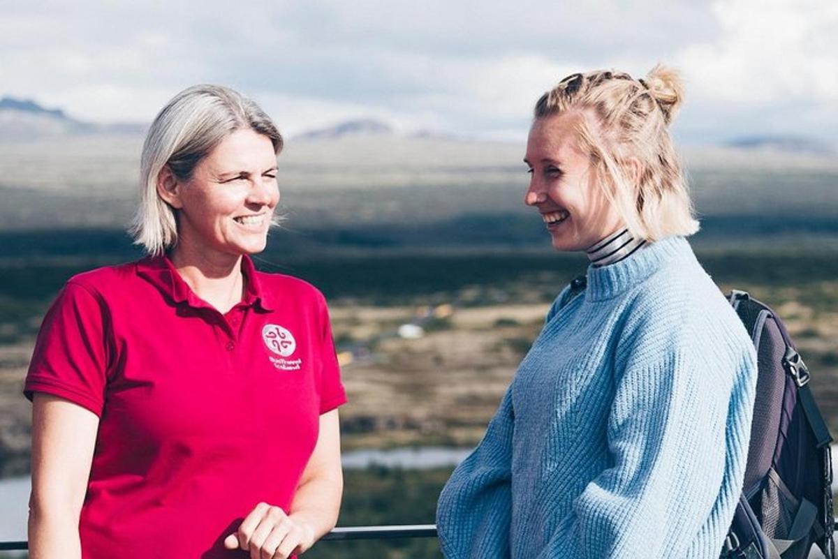 two women standing on top of a mountain