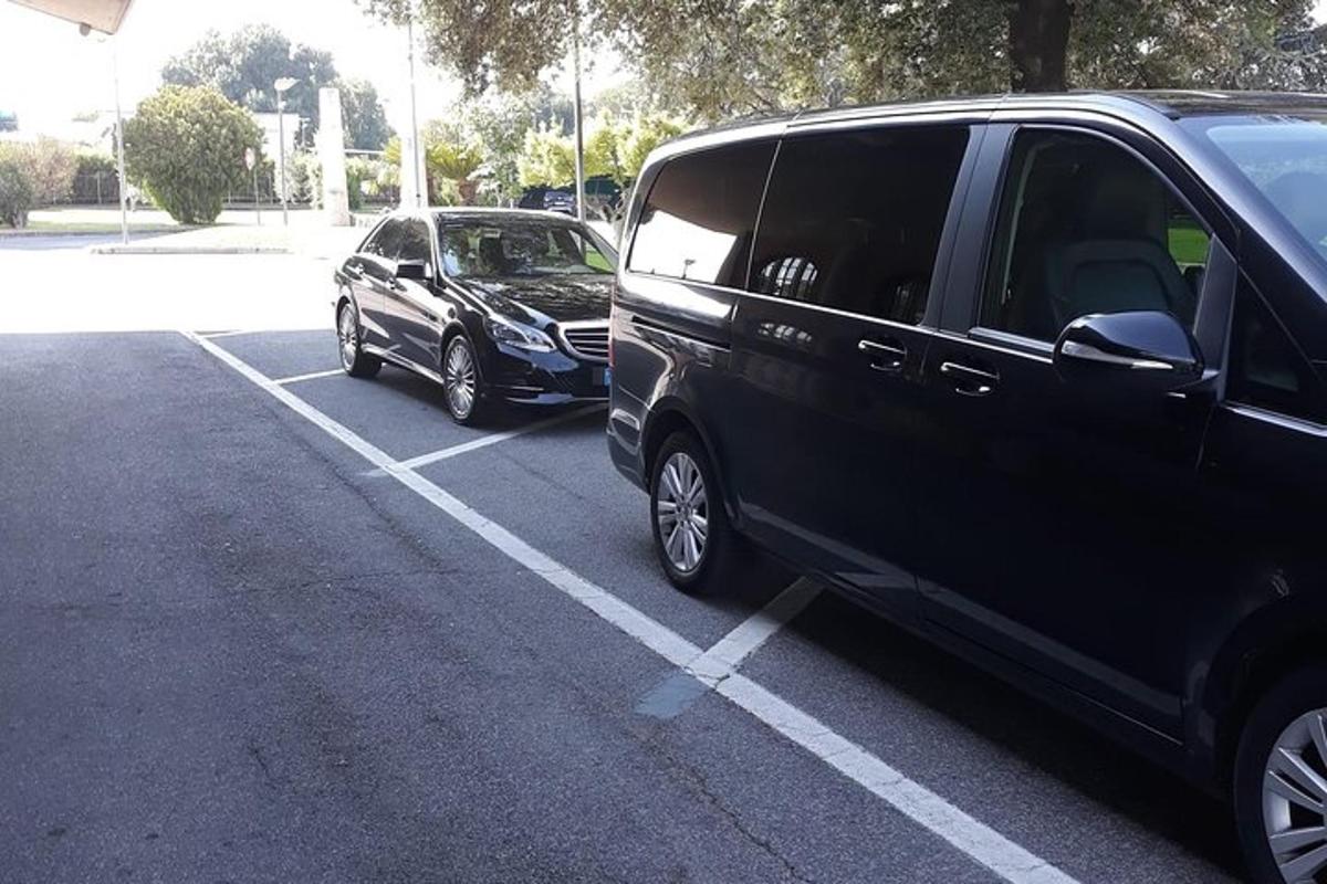 two black vans parked in a parking lot