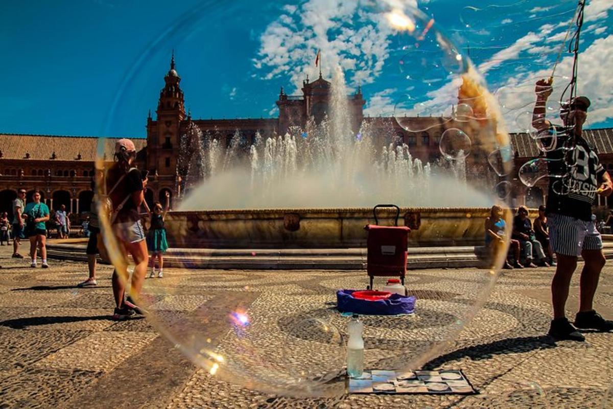 a water fountain in a city with people standing around it
