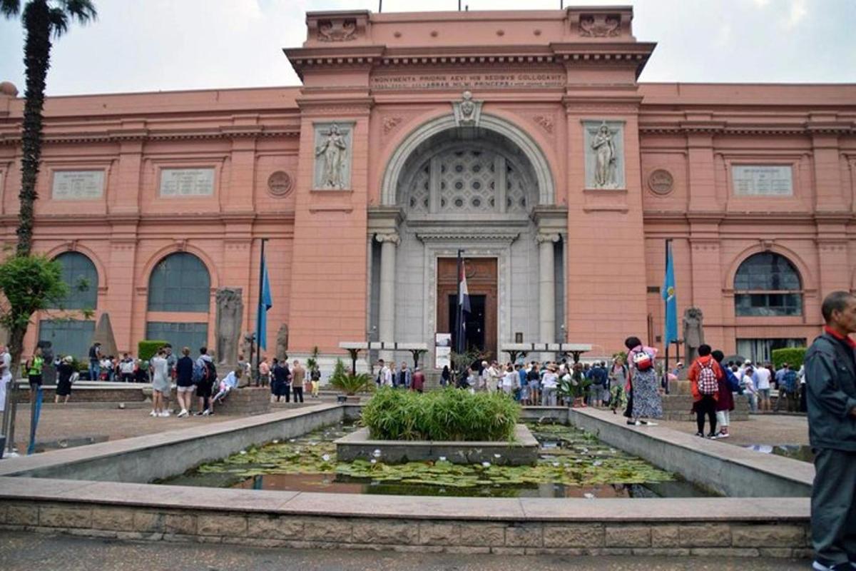 Un gran edificio con una fuente delante.