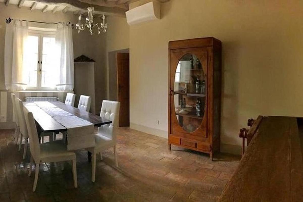 a dining room with a table and a wooden cabinet