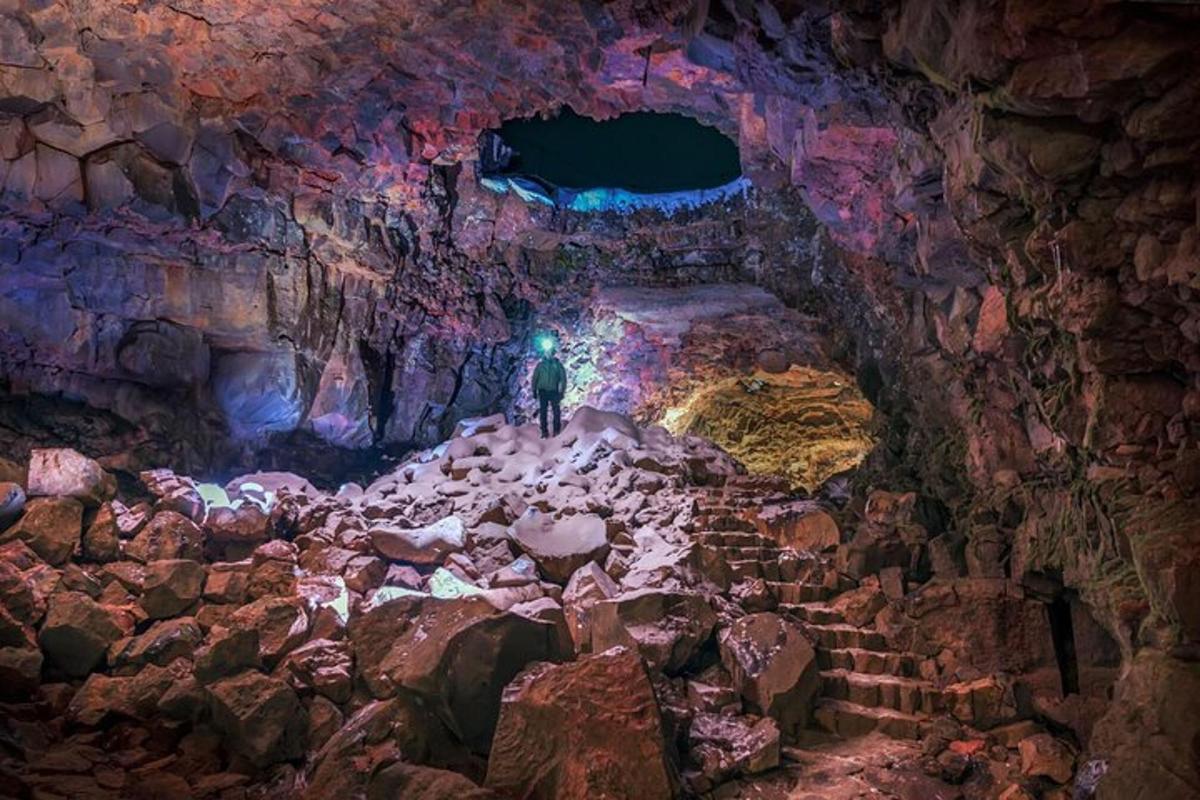 a person standing in a cave with rocks