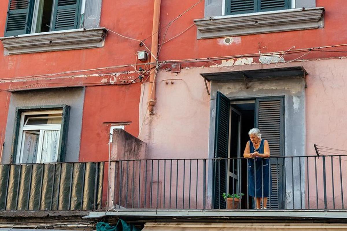 a woman standing on a balcony of a building