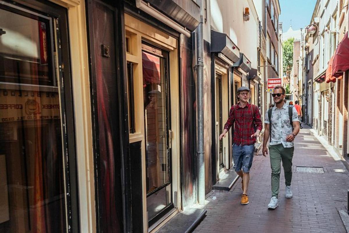 two men walking down a street in front of shops