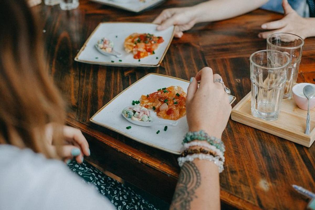 a woman sitting at a table with plates of food