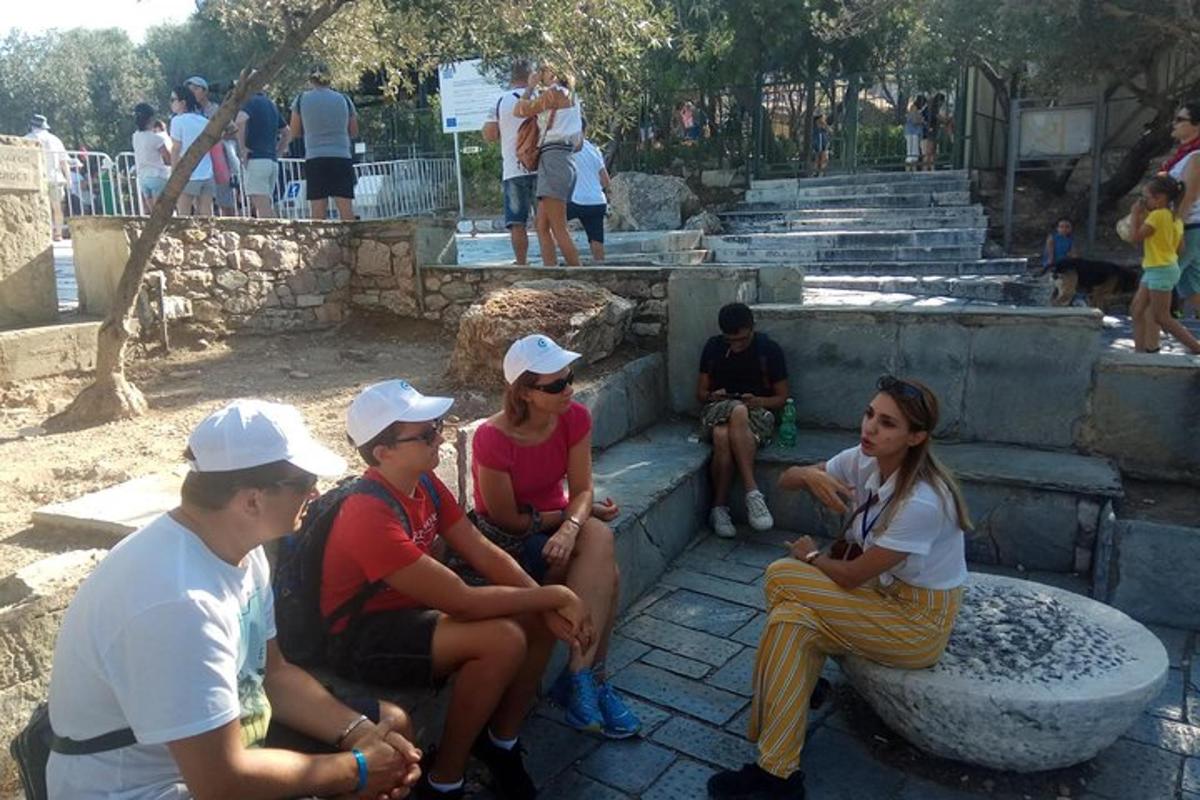 a group of people sitting on steps at a zoo
