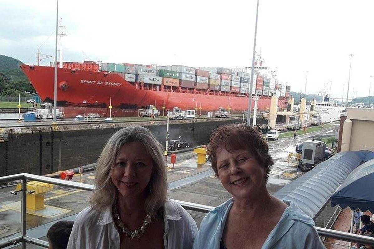due donne in piedi davanti a una nave portacontainer