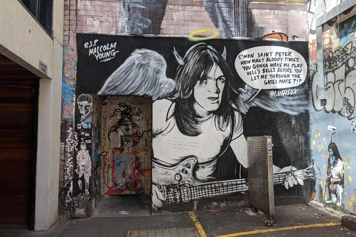 a wall with a painting of a woman on it