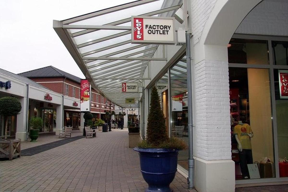 an empty shopping mall with a sign for a shopping center
