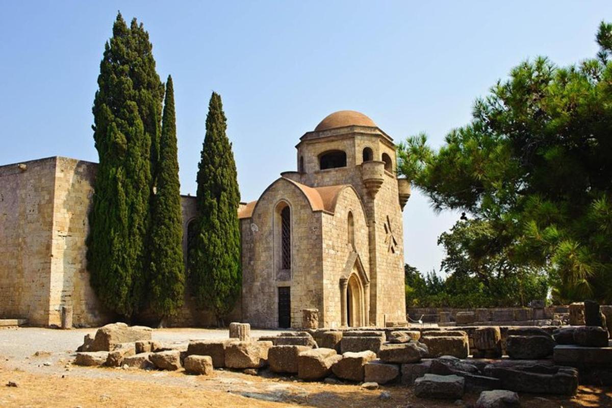 an old stone church with trees in front of it