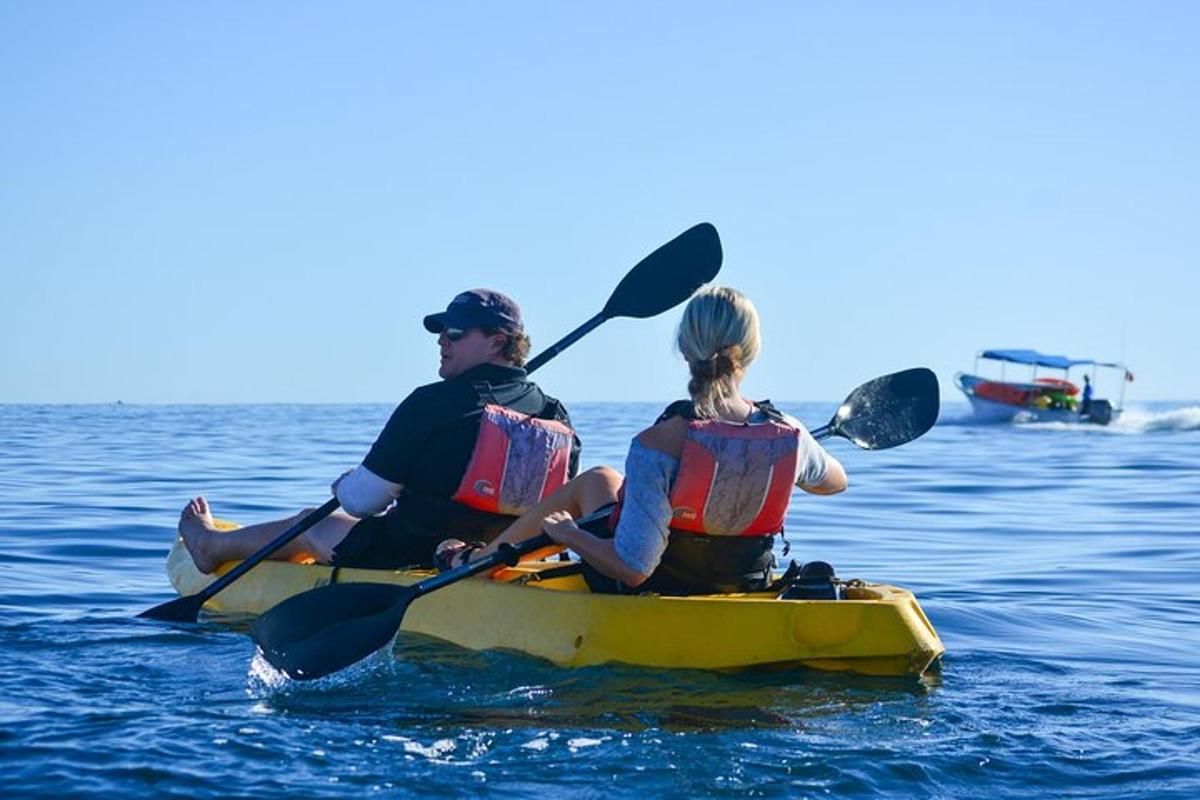 a man and woman in a kayak in the water