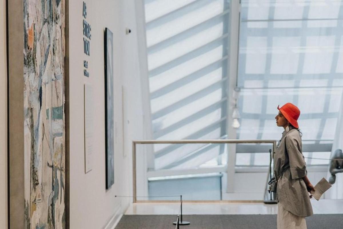 a woman walking past a window in a museum