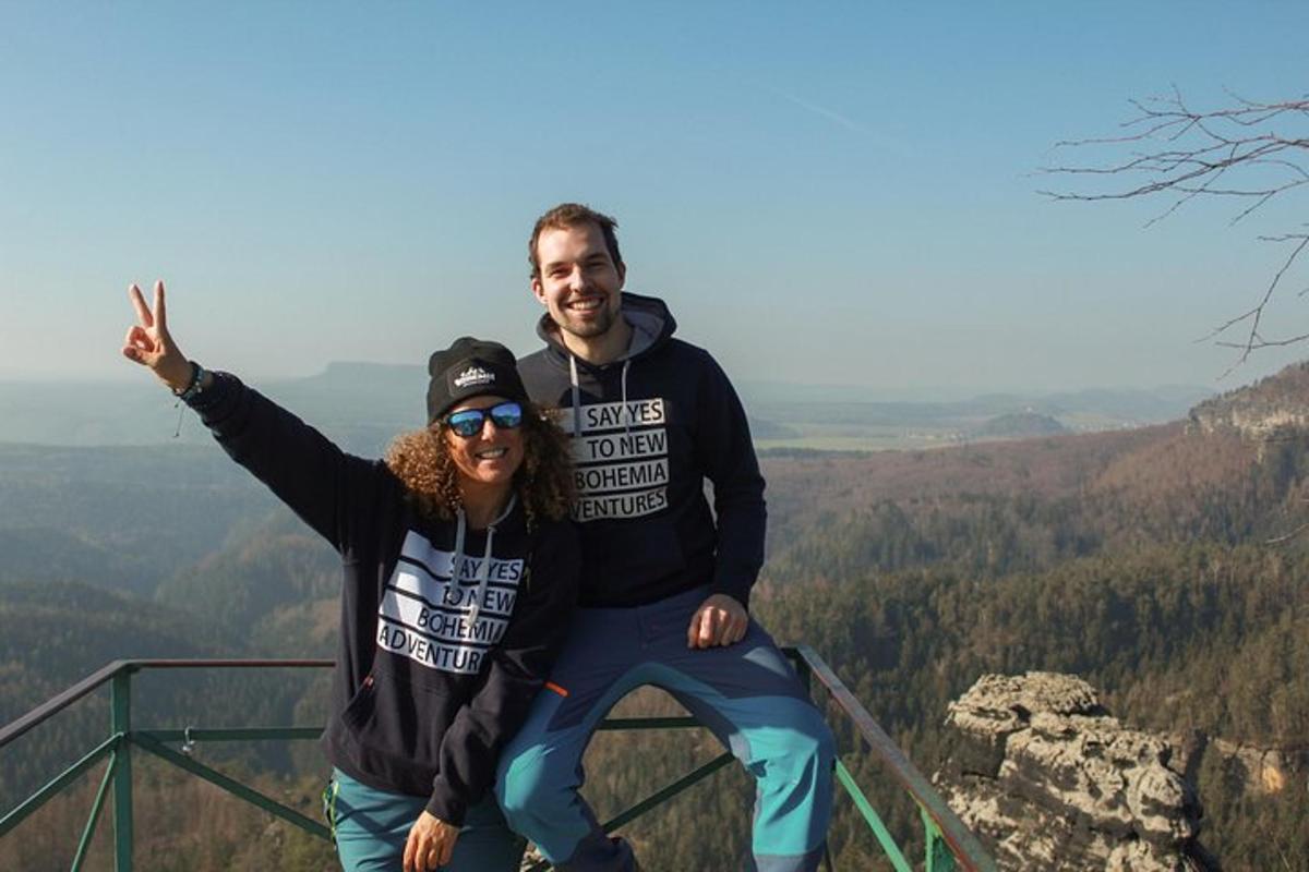 muž a žena stojící na vrcholu hory