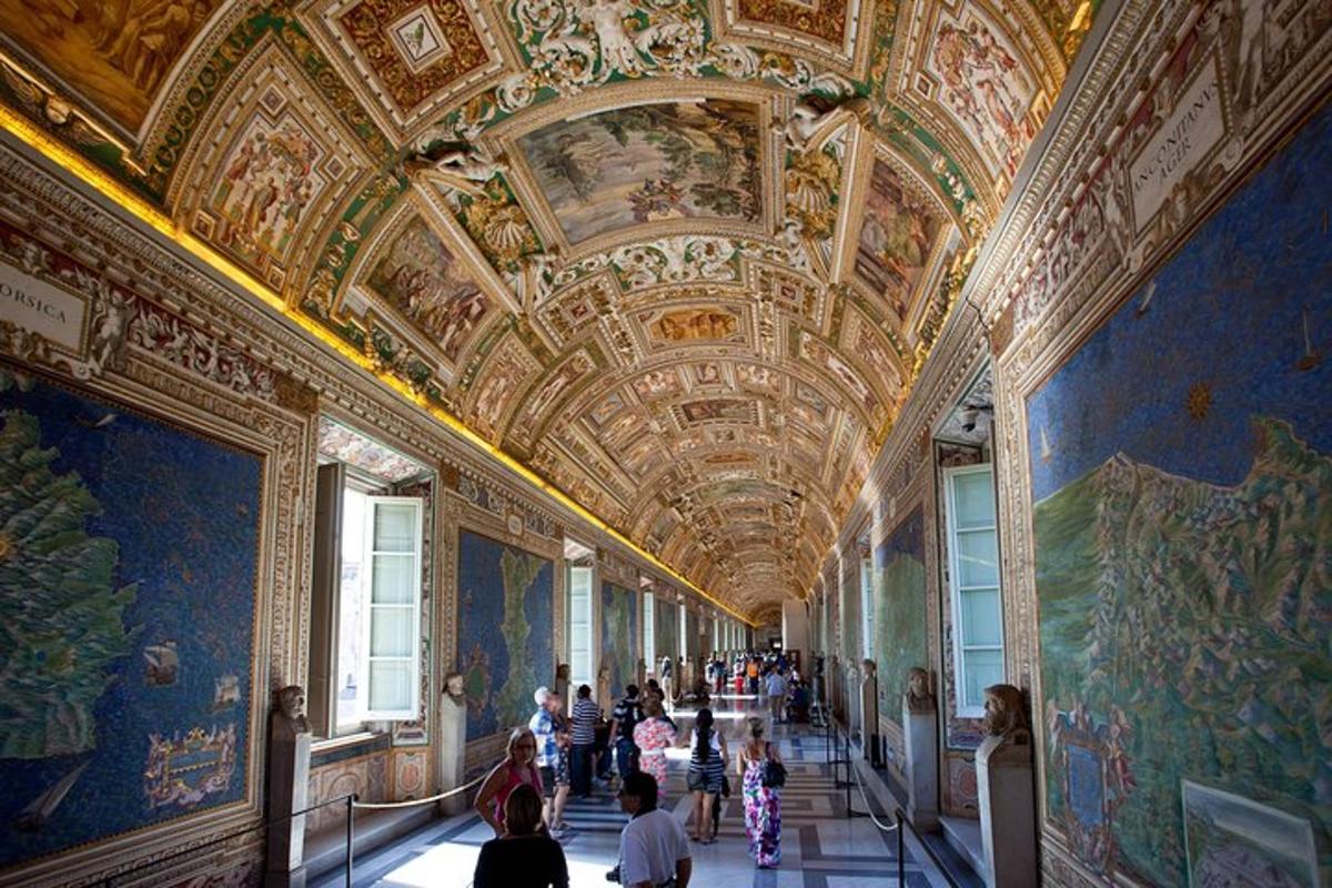 a group of people walking through a hallway in a museum